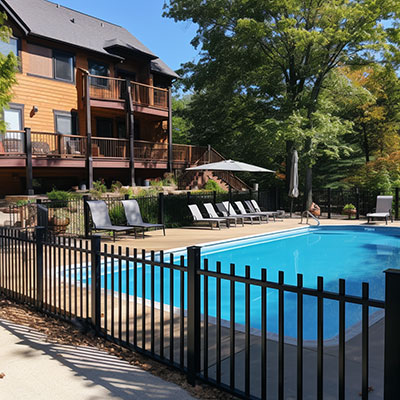 aluminum fence with black color around a pool area